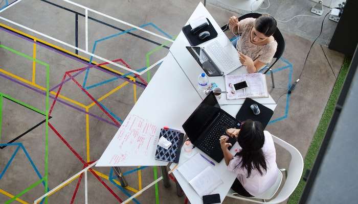 Two Coworkers Following Workplace Etiquette For Communication