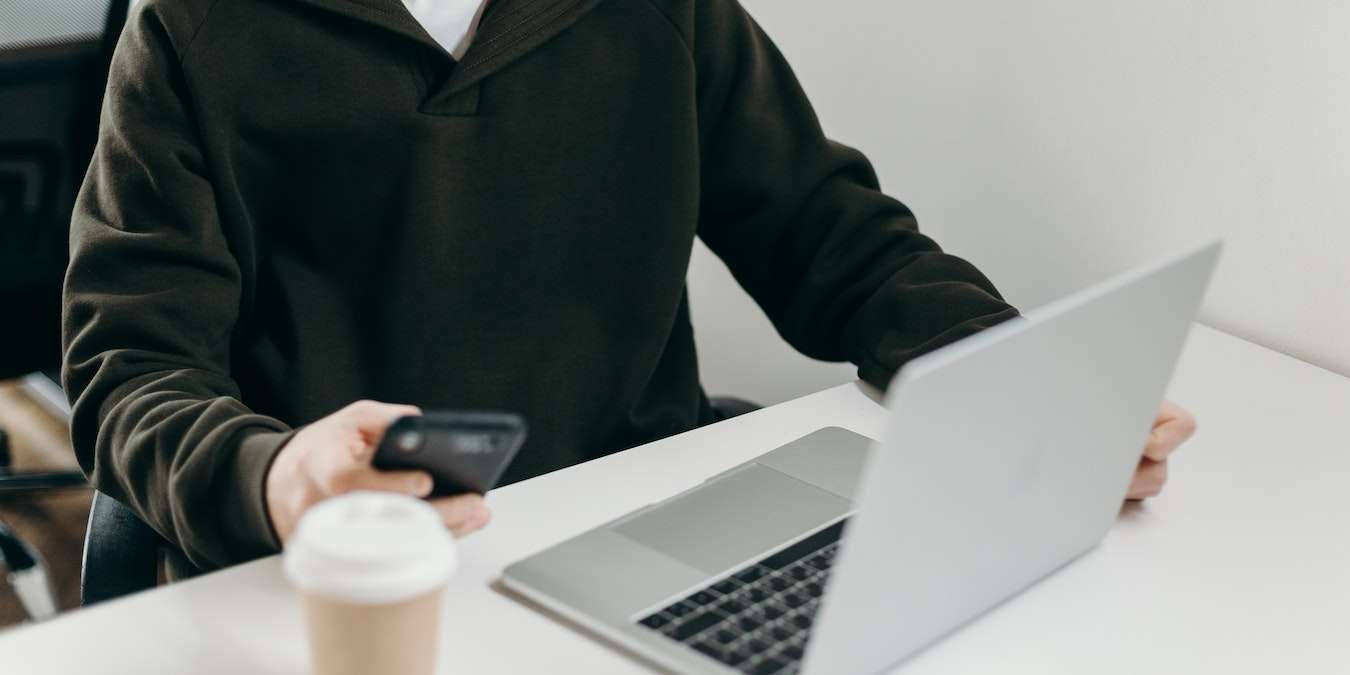 Man Working But On Cell Phone