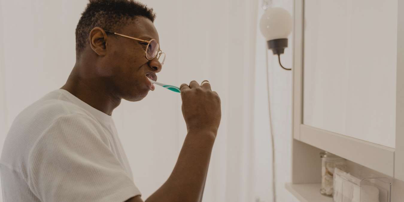 Man Brushing Teeth With Electric Toothbrush