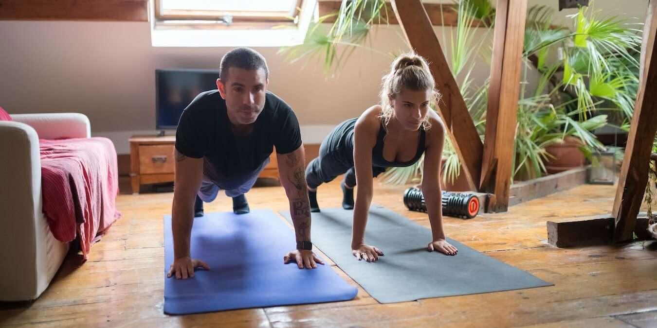 Two People Exercising At Home