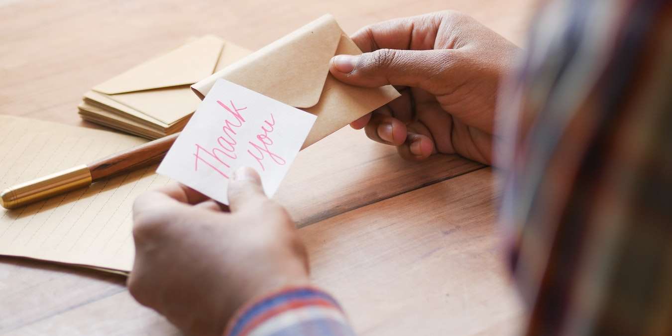 Person Writing Thank You Notes