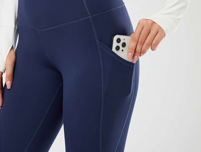 Woman Putting Smartphone in Leggings Pocket