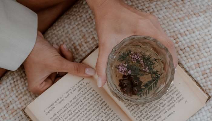 Woman Relaxing After Stressful Day With Herbal Tea