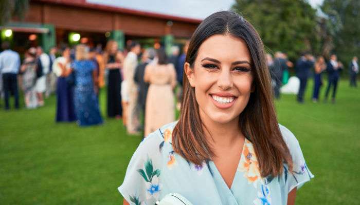 Young,beautiful,and,elegant,woman,with,wedding,guest,dress,smiling