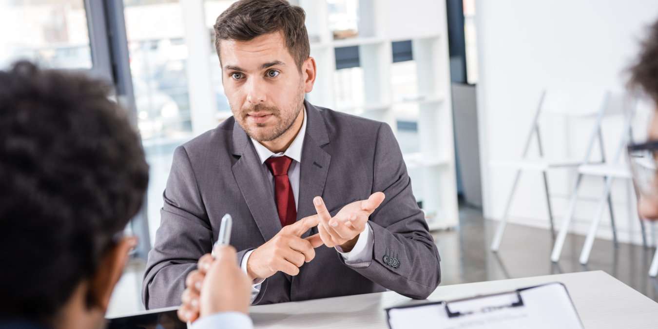 Man Asking Job Interview Questions With Hands